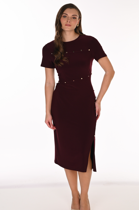 Woman wearing a burgundy dress with a white background